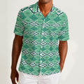 Button-down shirt featuring the Bloomgrid in Mint Mojito pattern with mint green, cream, and citrus-toned geometric floral shapes in a retro-inspired all-over print. Lightweight summer button down with coastal resort aesthetic, vintage Palm Springs style, botanical geometric pattern, maximalist fashion, indie streetwear, colorful vacation outfit, mod inspired design, artsy casualwear, breezy resortwear, expressive fashion, queer friendly style, and playful retro clothing perfect for beach vacations, brunch,