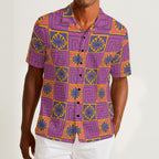 Button-down shirt featuring the Petal Circuit in Disco Fig pattern with bold purple, pink, orange, and cream geometric floral shapes in a retro-inspired all-over print. Lightweight statement shirt with maximalist fashion aesthetic, vintage resort style, mod inspired pattern, psychedelic floral design, indie streetwear, colorful vacation outfit vibe, expressive queer friendly fashion, artsy casualwear, retro geometric clothing, playful summer button down, and breezy resortwear perfect for festivals, travel