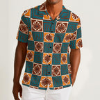 Button-down shirt featuring the Petal Circuit in Desert Teal pattern with teal, cream, rust, and golden geometric floral shapes in a retro-inspired all-over print. Lightweight summer shirt with vintage resort aesthetic, mod inspired fashion, indie streetwear, colorful vacation outfit vibe, artsy casualwear, expressive queer friendly style, and breezy statement clothing perfect for travel, festivals, brunch, beach vacations, and everyday summer wear.