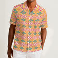 Button-down shirt featuring the Bloomgrid in Candy Cabana pattern with vibrant pink, coral, cream, and mint geometric floral shapes in a playful retro-inspired all-over print. Lightweight summer button down with maximalist fashion aesthetic, vintage resort style, tropical vacation outfit vibe, Palm Springs inspired design, colorful geometric floral pattern, indie fashion, artsy streetwear, mod inspired clothing, expressive queer friendly fashion, retro beachwear, statement summer shirt, and breezy resortwea