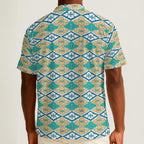 Button-down shirt featuring the Bloomgrid in Capri Coast pattern, with a blue coastal floral grid design and all-over print. Lightweight casual shirt with retro resort style, beach vacation fashion, botanical pattern, geometric floral print, artsy summer outfit, coastal grandma aesthetic, indie fashion, colorful resortwear, short sleeve statement shirt, vacation button down, breezy warm weather clothing, and unique patterned apparel for beach days, brunch, travel, festivals, and everyday summer wear.