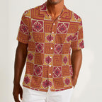Button-down shirt featuring the Petal Circuit in Mulled Spice pattern with warm rust, cream, plum, and golden geometric floral shapes in a retro-inspired all-over print. Lightweight statement shirt with vintage autumn aesthetic, maximalist fashion, indie streetwear, mod inspired design, expressive queer friendly style, artsy casualwear, and colorful resortwear perfect for festivals, travel, brunch, concerts, and everyday alternative summer wear.