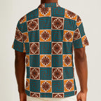 Button-down shirt featuring the Petal Circuit in Desert Teal pattern with teal, cream, rust, and golden geometric floral shapes in a retro-inspired all-over print. Lightweight summer shirt with vintage resort aesthetic, mod inspired fashion, indie streetwear, colorful vacation outfit vibe, artsy casualwear, expressive queer friendly style, and breezy statement clothing perfect for travel, festivals, brunch, beach vacations, and everyday summer wear.