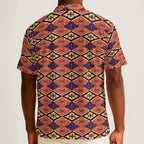 Button-down shirt featuring the Bloomgrid in Disco Dahlia pattern with vibrant pink, orange, and cream geometric floral shapes in a retro-inspired all-over print. Colorful statement shirt with maximalist fashion aesthetic, vintage resort style, mod inspired pattern, artsy streetwear, retro floral design, indie fashion, bold vacation outfit, short sleeve summer button down, playful geometric print, expressive fashion, queer friendly style, and lightweight resortwear perfect for festivals, travel, beach vacat