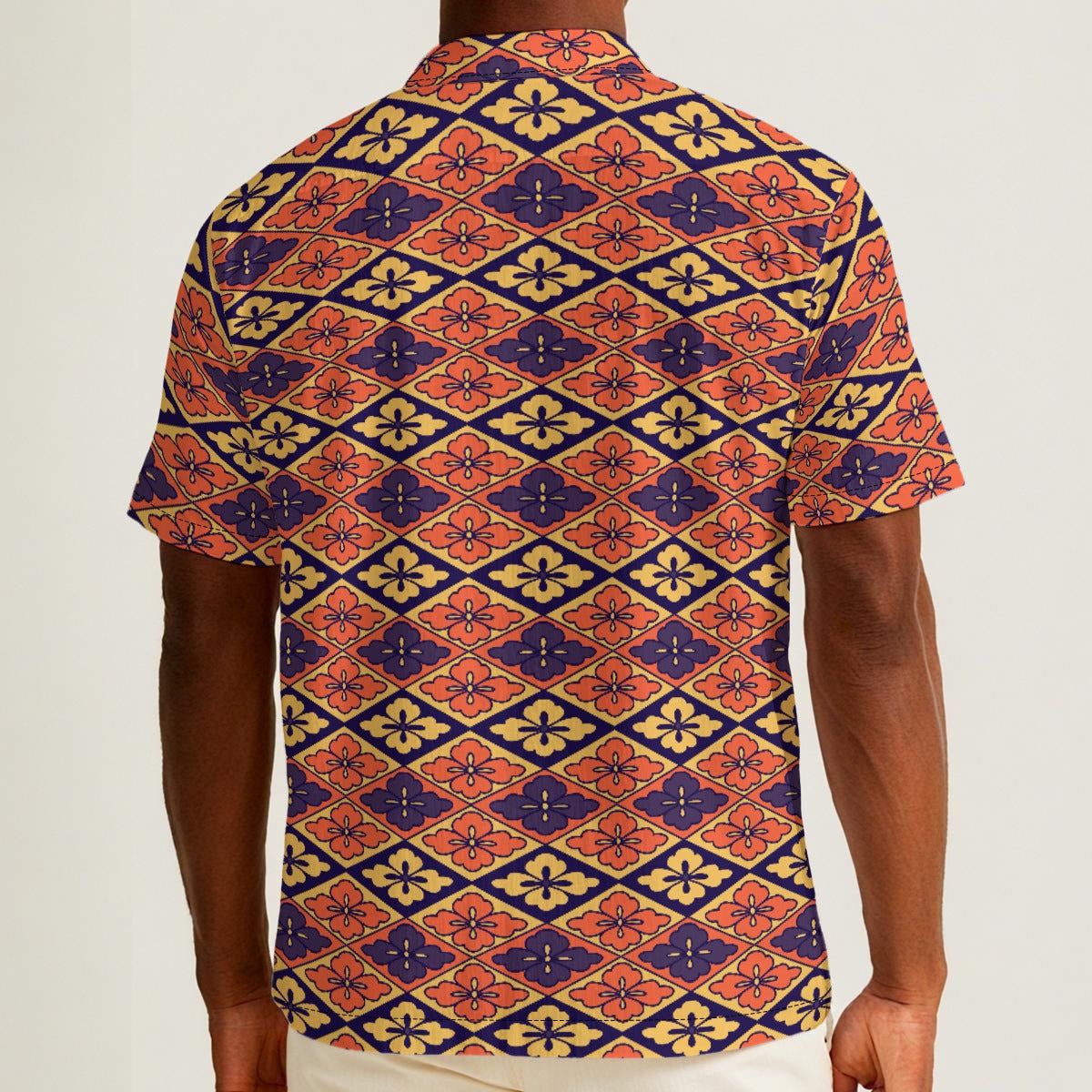 Button-down shirt featuring the Bloomgrid in Disco Dahlia pattern with vibrant pink, orange, and cream geometric floral shapes in a retro-inspired all-over print. Colorful statement shirt with maximalist fashion aesthetic, vintage resort style, mod inspired pattern, artsy streetwear, retro floral design, indie fashion, bold vacation outfit, short sleeve summer button down, playful geometric print, expressive fashion, queer friendly style, and lightweight resortwear perfect for festivals, travel, beach vacat