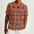 Button-down shirt featuring the Bloomgrid in Disco Dahlia pattern with vibrant pink, orange, and cream geometric floral shapes in a retro-inspired all-over print. Colorful statement shirt with maximalist fashion aesthetic, vintage resort style, mod inspired pattern, artsy streetwear, retro floral design, indie fashion, bold vacation outfit, short sleeve summer button down, playful geometric print, expressive fashion, queer friendly style, and lightweight resortwear perfect for festivals, travel, beach vacat