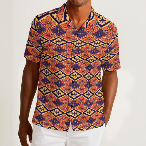 Button-down shirt featuring the Bloomgrid in Disco Dahlia pattern with vibrant pink, orange, and cream geometric floral shapes in a retro-inspired all-over print. Colorful statement shirt with maximalist fashion aesthetic, vintage resort style, mod inspired pattern, artsy streetwear, retro floral design, indie fashion, bold vacation outfit, short sleeve summer button down, playful geometric print, expressive fashion, queer friendly style, and lightweight resortwear perfect for festivals, travel, beach vacat