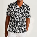 Button-down shirt featuring a playful black-and-white ghost pattern in an all-over spooky print design. Lightweight summer shirt with spooky cute aesthetic, vintage Halloween style, alternative fashion, indie streetwear, whimsical ghost artwork, expressive queer friendly fashion, retro novelty print, artsy casualwear, and statement resortwear perfect for festivals, concerts, Halloween parties, vacations, brunch, and everyday alternative wear.