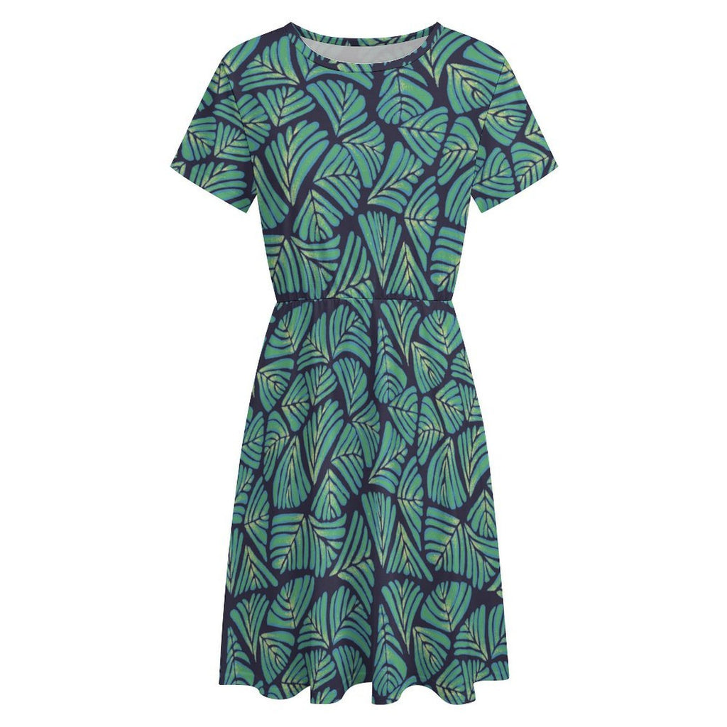 Short sleeve dress featuring the Frondescence pattern with layered tropical foliage in deep green botanical tones and an all-over nature-inspired print. Flowy casual dress with earthy jungle aesthetic, maximalist fashion, indie streetwear, botanical artwork, expressive queer friendly style, artsy everyday wear, and retro-inspired tropical clothing perfect for vacations, brunch, festivals, casual outings, and comfortable everyday alternative fashion.