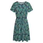 Short sleeve dress featuring the Frondescence pattern with layered tropical foliage in deep green botanical tones and an all-over nature-inspired print. Flowy casual dress with earthy jungle aesthetic, maximalist fashion, indie streetwear, botanical artwork, expressive queer friendly style, artsy everyday wear, and retro-inspired tropical clothing perfect for vacations, brunch, festivals, casual outings, and comfortable everyday alternative fashion.
