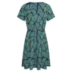 Short sleeve dress featuring the Frondescence pattern with layered tropical foliage in deep green botanical tones and an all-over nature-inspired print. Flowy casual dress with earthy jungle aesthetic, maximalist fashion, indie streetwear, botanical artwork, expressive queer friendly style, artsy everyday wear, and retro-inspired tropical clothing perfect for vacations, brunch, festivals, casual outings, and comfortable everyday alternative fashion.