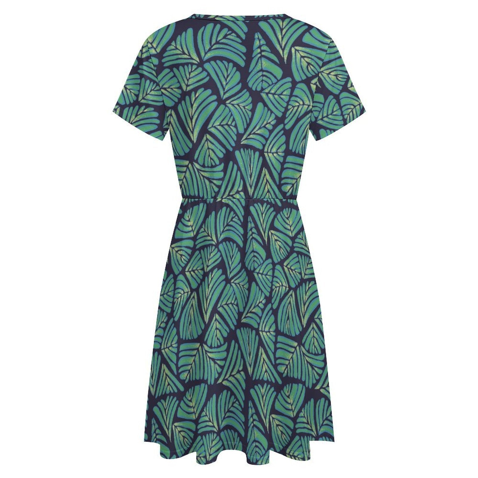 Short sleeve dress featuring the Frondescence pattern with layered tropical foliage in deep green botanical tones and an all-over nature-inspired print. Flowy casual dress with earthy jungle aesthetic, maximalist fashion, indie streetwear, botanical artwork, expressive queer friendly style, artsy everyday wear, and retro-inspired tropical clothing perfect for vacations, brunch, festivals, casual outings, and comfortable everyday alternative fashion.