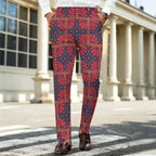 Dress pants featuring the Petalburst Tile in Midnight Fiesta pattern with bold floral-inspired geometric shapes in rich midnight blue, orange, pink, and cream tones. Statement trousers with retro maximalist aesthetic, indie streetwear, mod inspired fashion, expressive queer friendly style, artsy alternative clothing, colorful geometric pattern, and bold patterned pants perfect for concerts, parties, festivals, creative workwear, nightlife, and everyday alternative fashion.