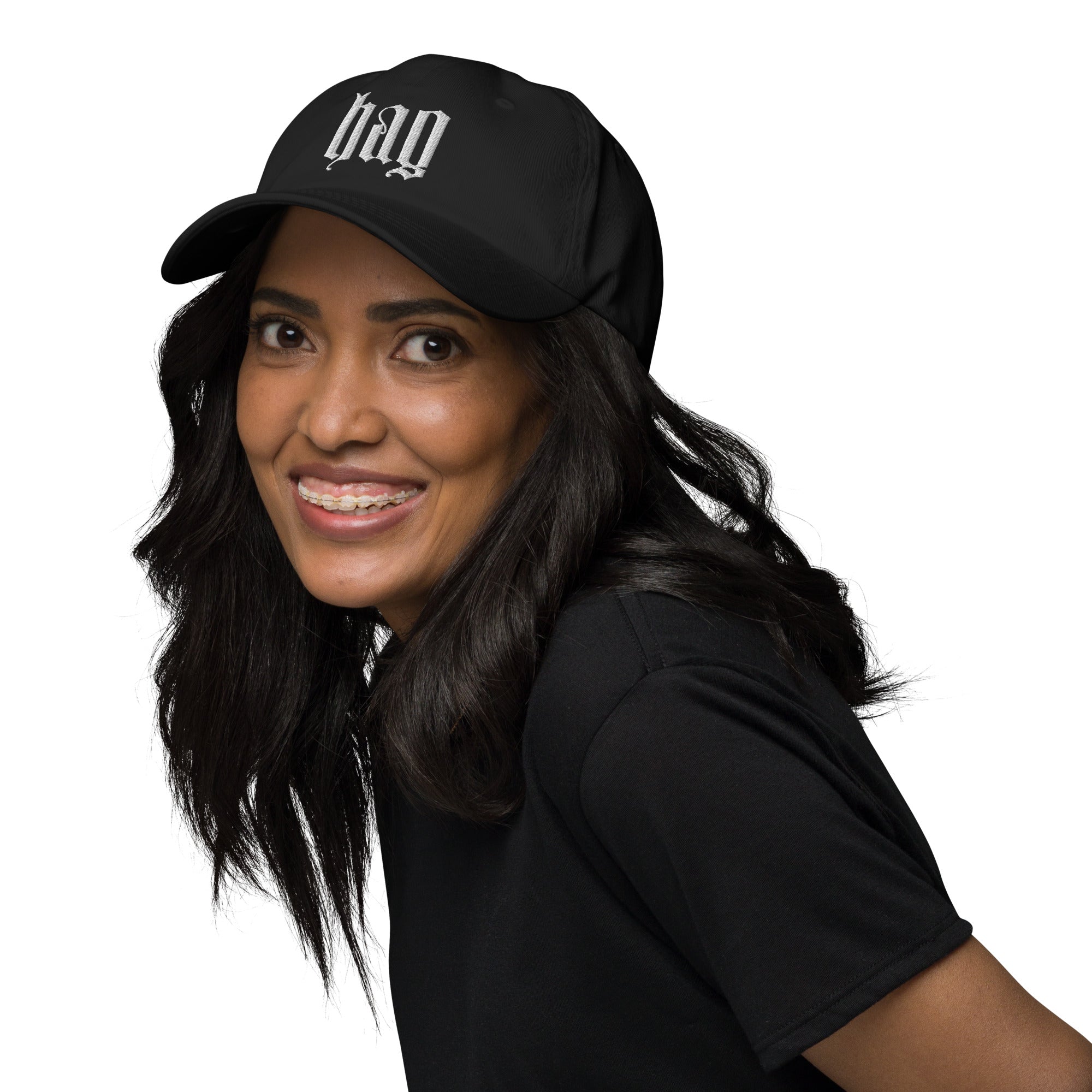 Black dad hat embroidered with the word ‘HAG’ in ornate vintage gothic lettering. Alternative fashion accessory with queer streetwear aesthetic, witchy fashion, sarcastic humor, feminist style, indie fashion, spooky cute apparel, gothic embroidery, punk inspired streetwear, adjustable baseball cap, casual everyday alternative outfit, internet humor fashion, artsy accessory, and edgy statement hat for concerts, festivals, casual wear, and alternative wardrobes.