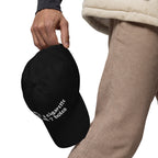 Baseball cap embroidered with the phrase ‘I Have a Cigarette in All 7 Holes’ in ornate vintage gothic lettering. Alternative fashion accessory with edgy internet humor, queer streetwear aesthetic, punk inspired style, ironic meme fashion, tattoo inspired typography, goth streetwear, adjustable dad hat, casual alternative outfit accessory, artsy statement cap, chaotic humor apparel, indie fashion, and expressive alternative clothing for concerts, festivals, everyday wear, and alternative wardrobes.