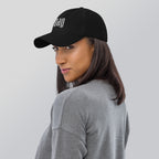 Black dad hat embroidered with the word ‘HAG’ in ornate vintage gothic lettering. Alternative fashion accessory with queer streetwear aesthetic, witchy fashion, sarcastic humor, feminist style, indie fashion, spooky cute apparel, gothic embroidery, punk inspired streetwear, adjustable baseball cap, casual everyday alternative outfit, internet humor fashion, artsy accessory, and edgy statement hat for concerts, festivals, casual wear, and alternative wardrobes.
