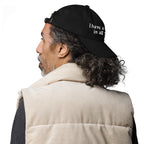 Baseball cap embroidered with the phrase ‘I Have a Cigarette in All 7 Holes’ in ornate vintage gothic lettering. Alternative fashion accessory with edgy internet humor, queer streetwear aesthetic, punk inspired style, ironic meme fashion, tattoo inspired typography, goth streetwear, adjustable dad hat, casual alternative outfit accessory, artsy statement cap, chaotic humor apparel, indie fashion, and expressive alternative clothing for concerts, festivals, everyday wear, and alternative wardrobes.