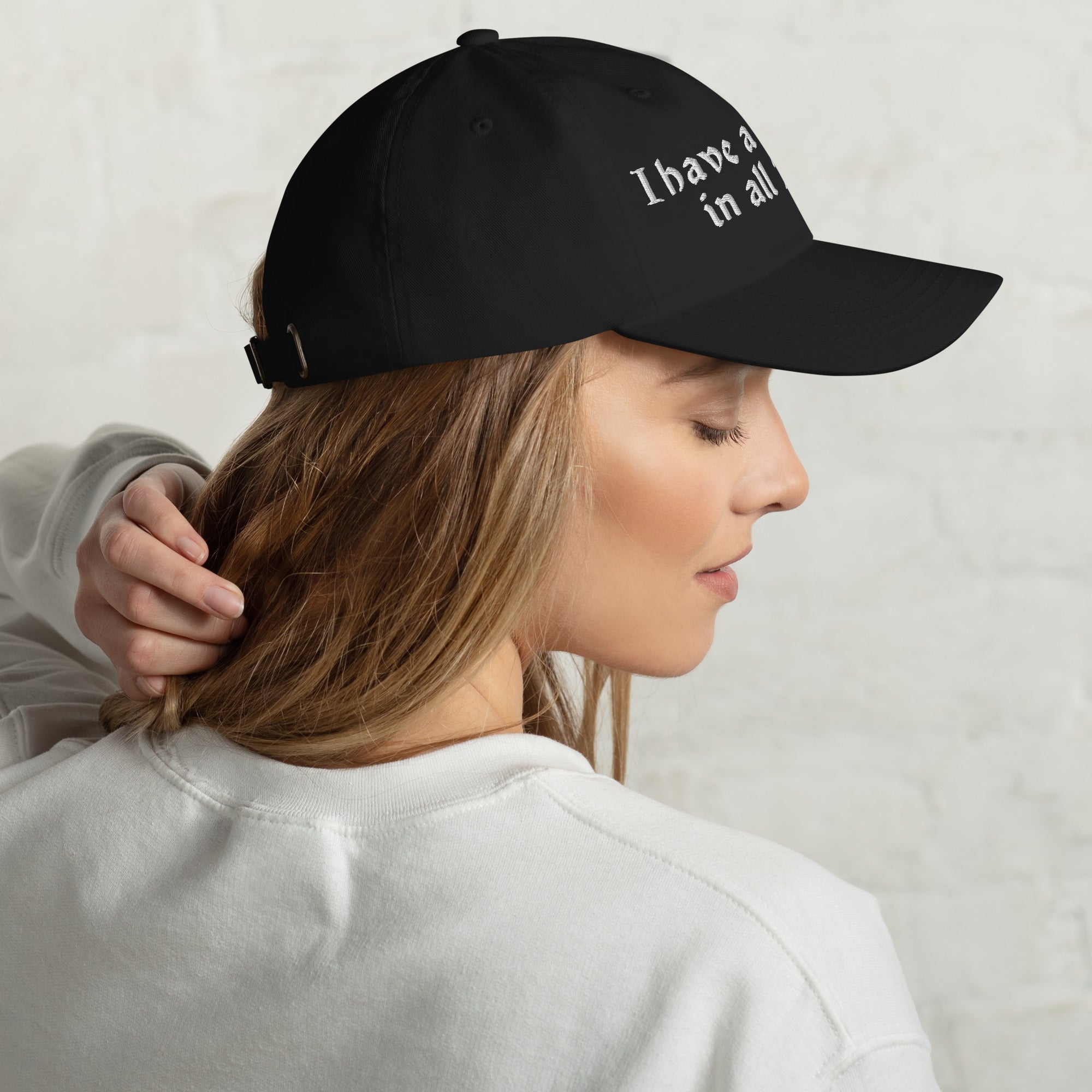 Baseball cap embroidered with the phrase ‘I Have a Cigarette in All 7 Holes’ in ornate vintage gothic lettering. Alternative fashion accessory with edgy internet humor, queer streetwear aesthetic, punk inspired style, ironic meme fashion, tattoo inspired typography, goth streetwear, adjustable dad hat, casual alternative outfit accessory, artsy statement cap, chaotic humor apparel, indie fashion, and expressive alternative clothing for concerts, festivals, everyday wear, and alternative wardrobes.