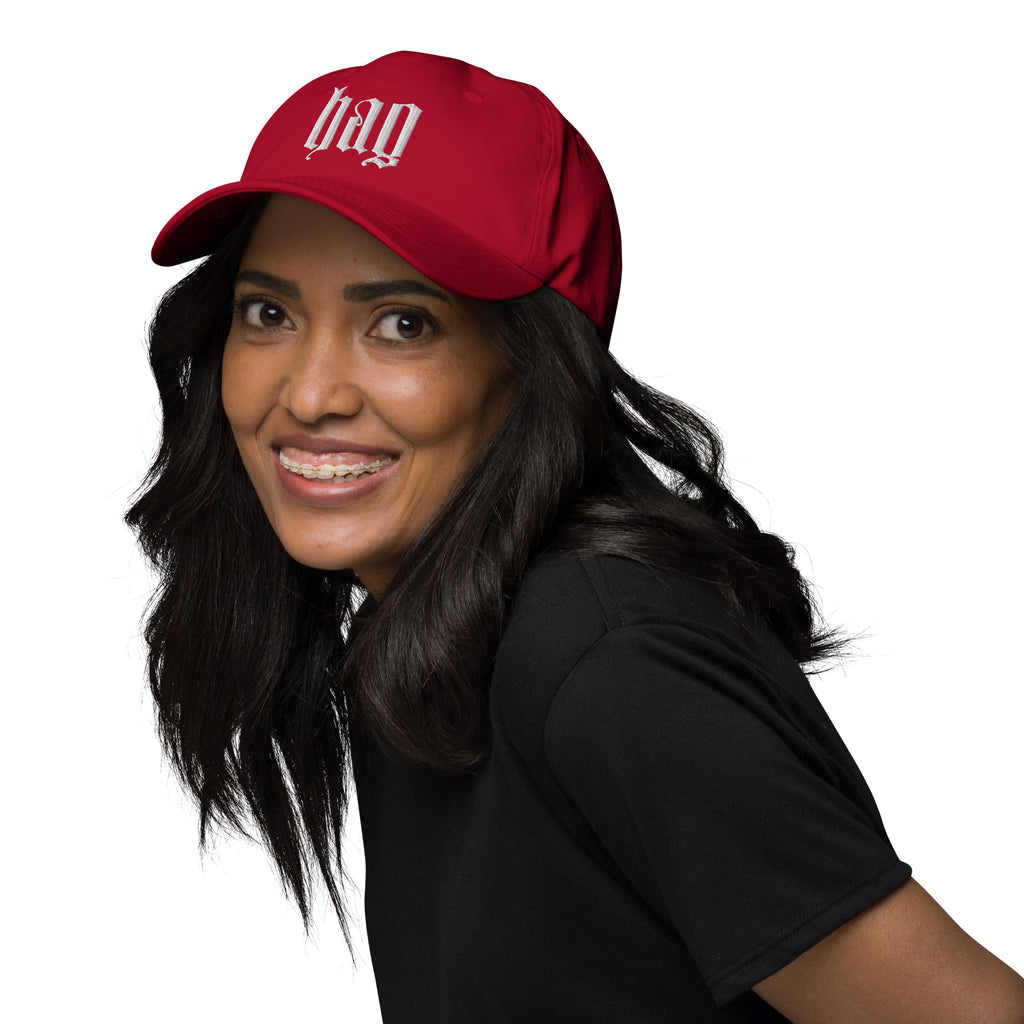 Black dad hat embroidered with the word ‘HAG’ in ornate vintage gothic lettering. Alternative fashion accessory with queer streetwear aesthetic, witchy fashion, sarcastic humor, feminist style, indie fashion, spooky cute apparel, gothic embroidery, punk inspired streetwear, adjustable baseball cap, casual everyday alternative outfit, internet humor fashion, artsy accessory, and edgy statement hat for concerts, festivals, casual wear, and alternative wardrobes.