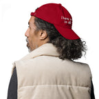 Baseball cap embroidered with the phrase ‘I Have a Cigarette in All 7 Holes’ in ornate vintage gothic lettering. Alternative fashion accessory with edgy internet humor, queer streetwear aesthetic, punk inspired style, ironic meme fashion, tattoo inspired typography, goth streetwear, adjustable dad hat, casual alternative outfit accessory, artsy statement cap, chaotic humor apparel, indie fashion, and expressive alternative clothing for concerts, festivals, everyday wear, and alternative wardrobes.