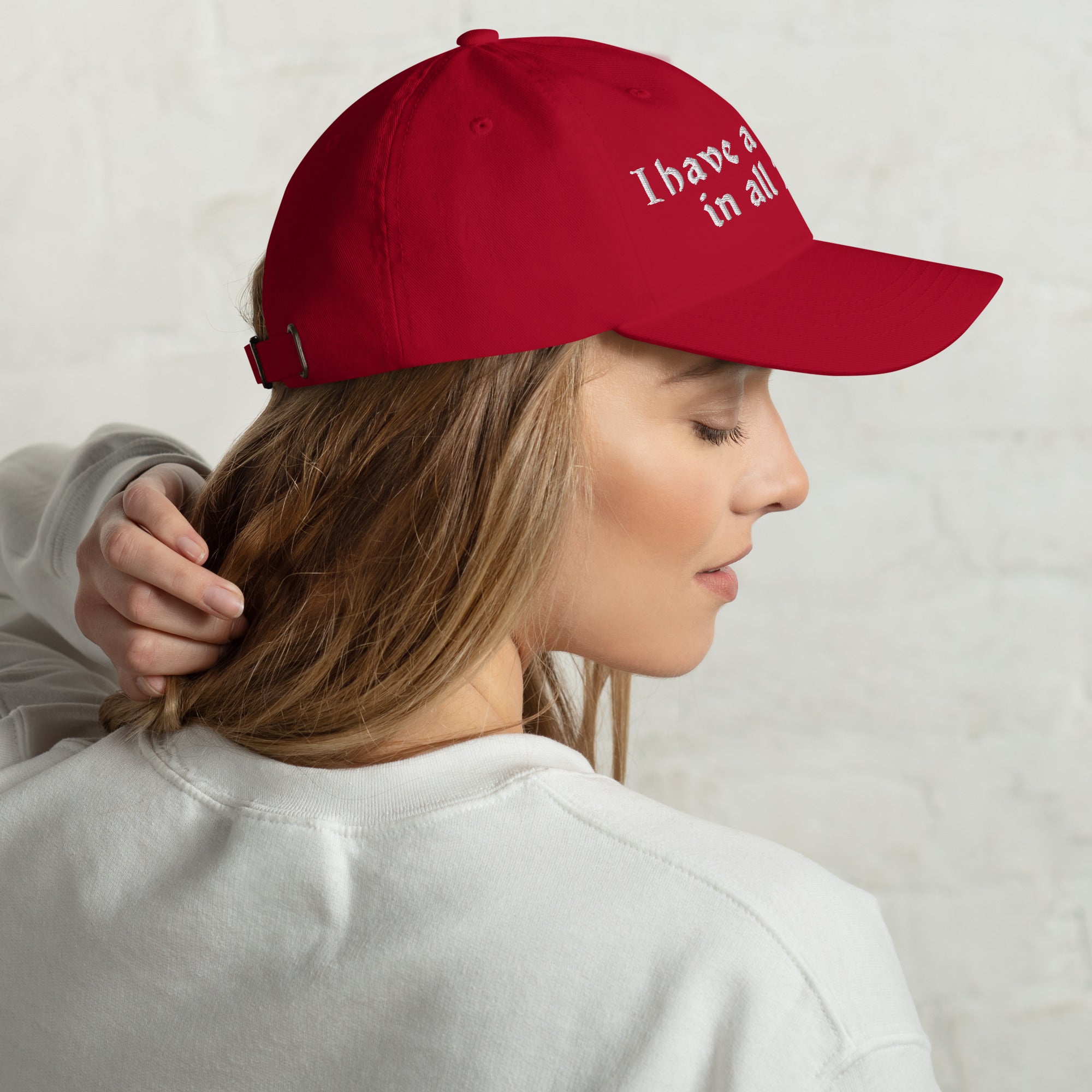 Baseball cap embroidered with the phrase ‘I Have a Cigarette in All 7 Holes’ in ornate vintage gothic lettering. Alternative fashion accessory with edgy internet humor, queer streetwear aesthetic, punk inspired style, ironic meme fashion, tattoo inspired typography, goth streetwear, adjustable dad hat, casual alternative outfit accessory, artsy statement cap, chaotic humor apparel, indie fashion, and expressive alternative clothing for concerts, festivals, everyday wear, and alternative wardrobes.