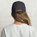 Baseball cap embroidered with the phrase ‘I Have a Cigarette in All 7 Holes’ in ornate vintage gothic lettering. Alternative fashion accessory with edgy internet humor, queer streetwear aesthetic, punk inspired style, ironic meme fashion, tattoo inspired typography, goth streetwear, adjustable dad hat, casual alternative outfit accessory, artsy statement cap, chaotic humor apparel, indie fashion, and expressive alternative clothing for concerts, festivals, everyday wear, and alternative wardrobes.