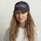 Baseball cap embroidered with the phrase ‘I Have a Cigarette in All 7 Holes’ in ornate vintage gothic lettering. Alternative fashion accessory with edgy internet humor, queer streetwear aesthetic, punk inspired style, ironic meme fashion, tattoo inspired typography, goth streetwear, adjustable dad hat, casual alternative outfit accessory, artsy statement cap, chaotic humor apparel, indie fashion, and expressive alternative clothing for concerts, festivals, everyday wear, and alternative wardrobes.