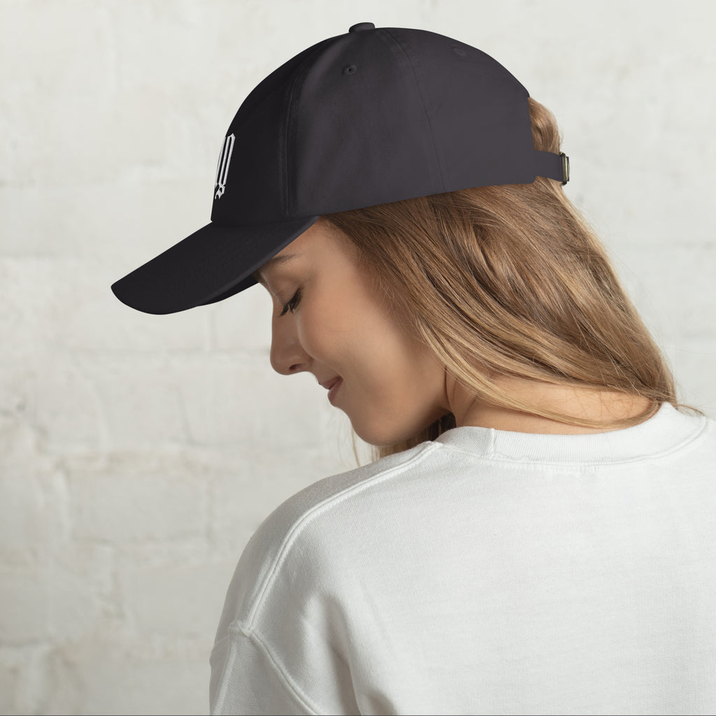 Black dad hat embroidered with the word ‘HAG’ in ornate vintage gothic lettering. Alternative fashion accessory with queer streetwear aesthetic, witchy fashion, sarcastic humor, feminist style, indie fashion, spooky cute apparel, gothic embroidery, punk inspired streetwear, adjustable baseball cap, casual everyday alternative outfit, internet humor fashion, artsy accessory, and edgy statement hat for concerts, festivals, casual wear, and alternative wardrobes.
