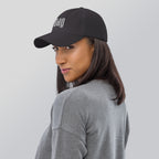 Black dad hat embroidered with the word ‘HAG’ in ornate vintage gothic lettering. Alternative fashion accessory with queer streetwear aesthetic, witchy fashion, sarcastic humor, feminist style, indie fashion, spooky cute apparel, gothic embroidery, punk inspired streetwear, adjustable baseball cap, casual everyday alternative outfit, internet humor fashion, artsy accessory, and edgy statement hat for concerts, festivals, casual wear, and alternative wardrobes.