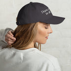 Baseball cap embroidered with the phrase ‘I Have a Cigarette in All 7 Holes’ in ornate vintage gothic lettering. Alternative fashion accessory with edgy internet humor, queer streetwear aesthetic, punk inspired style, ironic meme fashion, tattoo inspired typography, goth streetwear, adjustable dad hat, casual alternative outfit accessory, artsy statement cap, chaotic humor apparel, indie fashion, and expressive alternative clothing for concerts, festivals, everyday wear, and alternative wardrobes.
