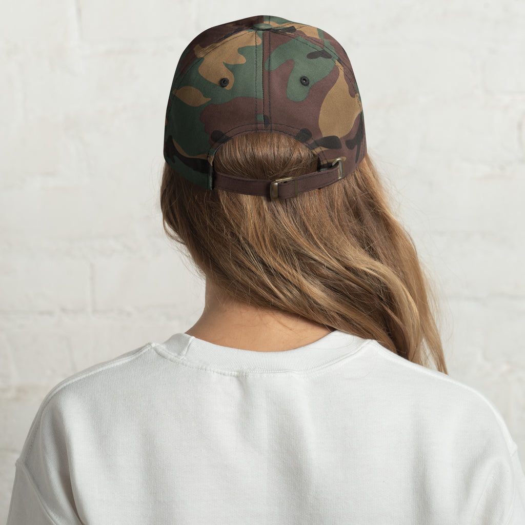 Baseball cap embroidered with the phrase ‘I Have a Cigarette in All 7 Holes’ in ornate vintage gothic lettering. Alternative fashion accessory with edgy internet humor, queer streetwear aesthetic, punk inspired style, ironic meme fashion, tattoo inspired typography, goth streetwear, adjustable dad hat, casual alternative outfit accessory, artsy statement cap, chaotic humor apparel, indie fashion, and expressive alternative clothing for concerts, festivals, everyday wear, and alternative wardrobes.