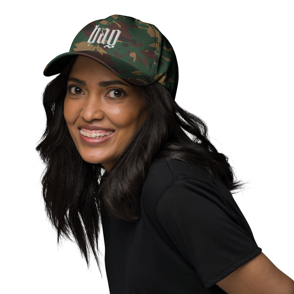 Black dad hat embroidered with the word ‘HAG’ in ornate vintage gothic lettering. Alternative fashion accessory with queer streetwear aesthetic, witchy fashion, sarcastic humor, feminist style, indie fashion, spooky cute apparel, gothic embroidery, punk inspired streetwear, adjustable baseball cap, casual everyday alternative outfit, internet humor fashion, artsy accessory, and edgy statement hat for concerts, festivals, casual wear, and alternative wardrobes.