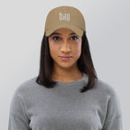 Black dad hat embroidered with the word ‘HAG’ in ornate vintage gothic lettering. Alternative fashion accessory with queer streetwear aesthetic, witchy fashion, sarcastic humor, feminist style, indie fashion, spooky cute apparel, gothic embroidery, punk inspired streetwear, adjustable baseball cap, casual everyday alternative outfit, internet humor fashion, artsy accessory, and edgy statement hat for concerts, festivals, casual wear, and alternative wardrobes.