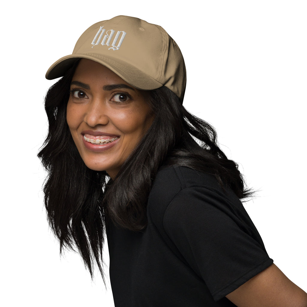 Black dad hat embroidered with the word ‘HAG’ in ornate vintage gothic lettering. Alternative fashion accessory with queer streetwear aesthetic, witchy fashion, sarcastic humor, feminist style, indie fashion, spooky cute apparel, gothic embroidery, punk inspired streetwear, adjustable baseball cap, casual everyday alternative outfit, internet humor fashion, artsy accessory, and edgy statement hat for concerts, festivals, casual wear, and alternative wardrobes.