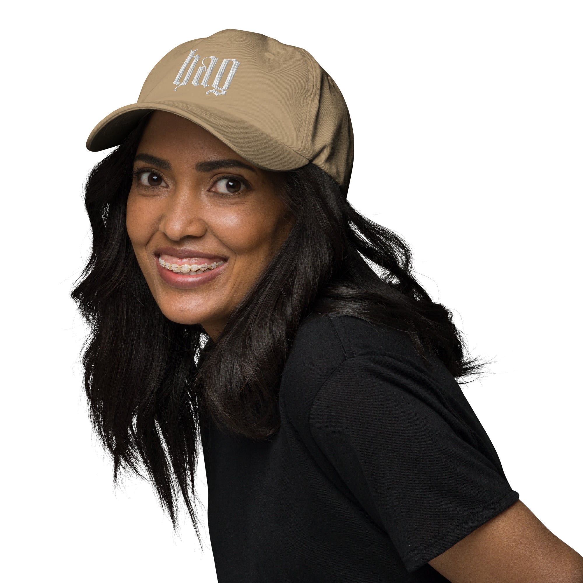 Black dad hat embroidered with the word ‘HAG’ in ornate vintage gothic lettering. Alternative fashion accessory with queer streetwear aesthetic, witchy fashion, sarcastic humor, feminist style, indie fashion, spooky cute apparel, gothic embroidery, punk inspired streetwear, adjustable baseball cap, casual everyday alternative outfit, internet humor fashion, artsy accessory, and edgy statement hat for concerts, festivals, casual wear, and alternative wardrobes.