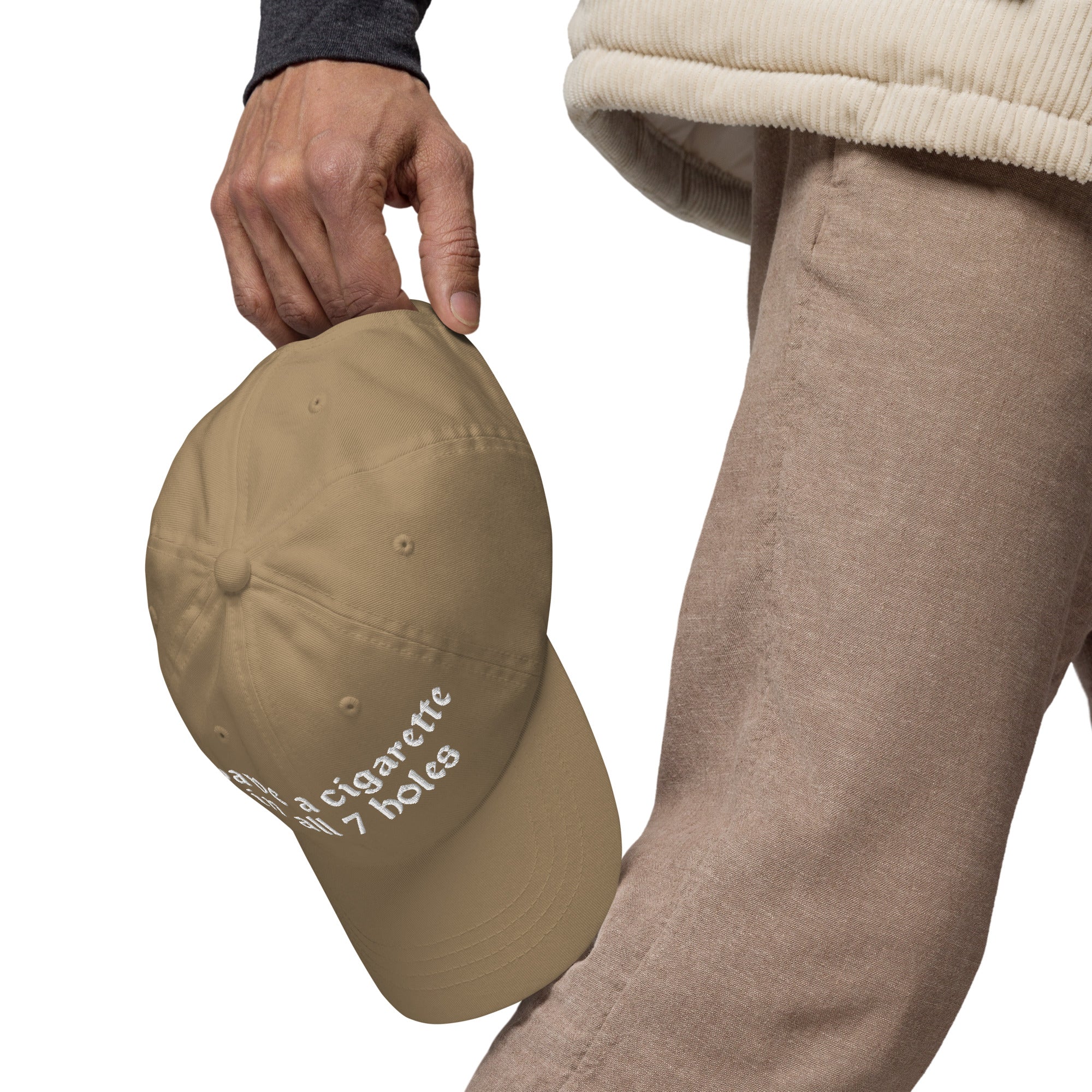 Baseball cap embroidered with the phrase ‘I Have a Cigarette in All 7 Holes’ in ornate vintage gothic lettering. Alternative fashion accessory with edgy internet humor, queer streetwear aesthetic, punk inspired style, ironic meme fashion, tattoo inspired typography, goth streetwear, adjustable dad hat, casual alternative outfit accessory, artsy statement cap, chaotic humor apparel, indie fashion, and expressive alternative clothing for concerts, festivals, everyday wear, and alternative wardrobes.