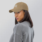 Black dad hat embroidered with the word ‘HAG’ in ornate vintage gothic lettering. Alternative fashion accessory with queer streetwear aesthetic, witchy fashion, sarcastic humor, feminist style, indie fashion, spooky cute apparel, gothic embroidery, punk inspired streetwear, adjustable baseball cap, casual everyday alternative outfit, internet humor fashion, artsy accessory, and edgy statement hat for concerts, festivals, casual wear, and alternative wardrobes.