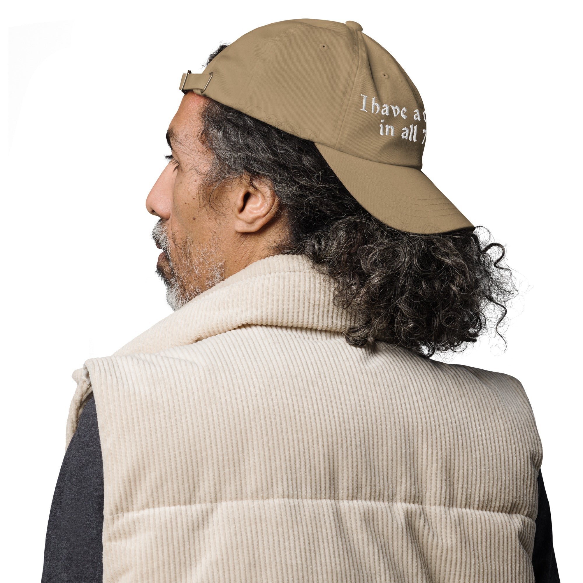 Baseball cap embroidered with the phrase ‘I Have a Cigarette in All 7 Holes’ in ornate vintage gothic lettering. Alternative fashion accessory with edgy internet humor, queer streetwear aesthetic, punk inspired style, ironic meme fashion, tattoo inspired typography, goth streetwear, adjustable dad hat, casual alternative outfit accessory, artsy statement cap, chaotic humor apparel, indie fashion, and expressive alternative clothing for concerts, festivals, everyday wear, and alternative wardrobes.