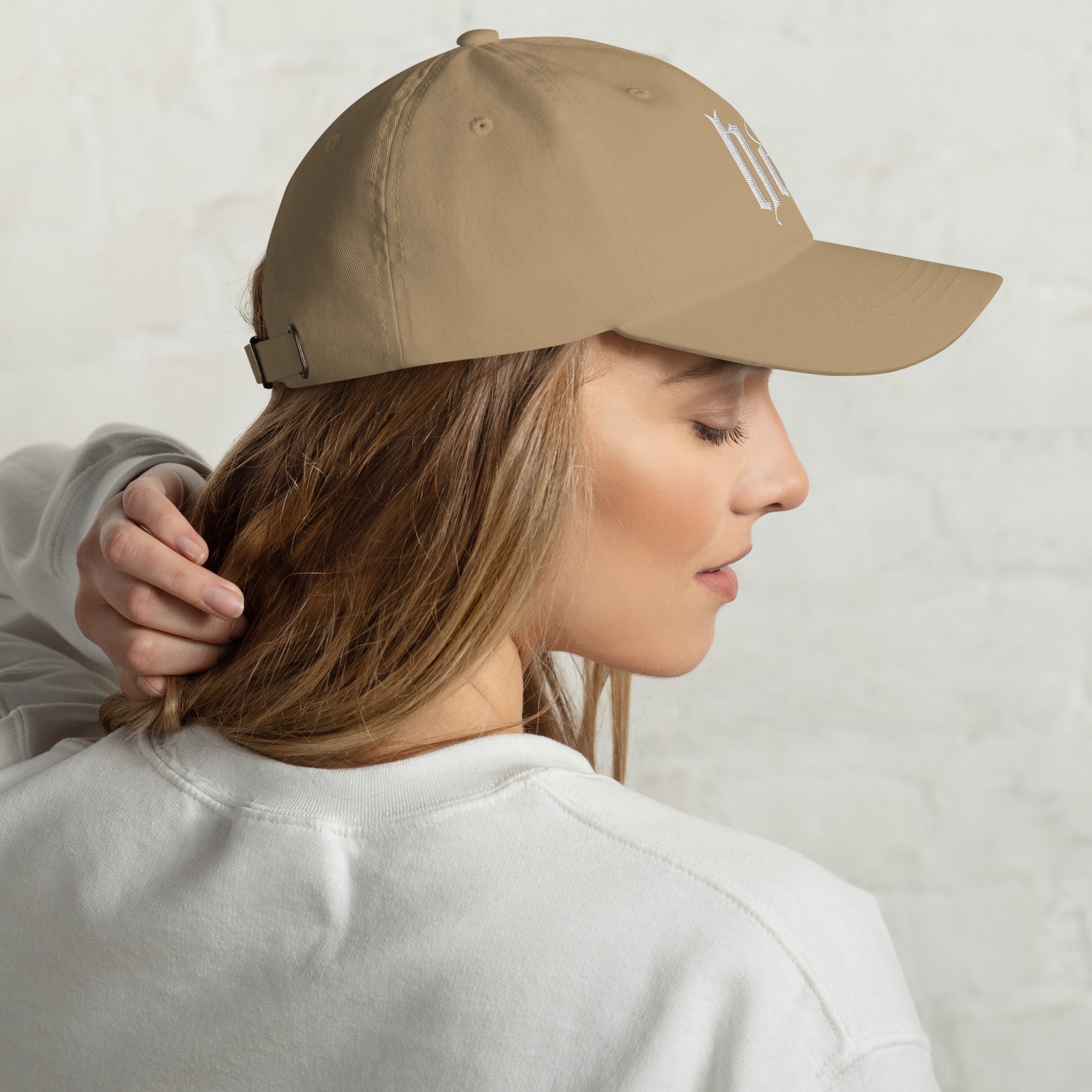 Black dad hat embroidered with the word ‘HAG’ in ornate vintage gothic lettering. Alternative fashion accessory with queer streetwear aesthetic, witchy fashion, sarcastic humor, feminist style, indie fashion, spooky cute apparel, gothic embroidery, punk inspired streetwear, adjustable baseball cap, casual everyday alternative outfit, internet humor fashion, artsy accessory, and edgy statement hat for concerts, festivals, casual wear, and alternative wardrobes.