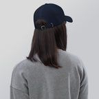 Black dad hat embroidered with the word ‘HAG’ in ornate vintage gothic lettering. Alternative fashion accessory with queer streetwear aesthetic, witchy fashion, sarcastic humor, feminist style, indie fashion, spooky cute apparel, gothic embroidery, punk inspired streetwear, adjustable baseball cap, casual everyday alternative outfit, internet humor fashion, artsy accessory, and edgy statement hat for concerts, festivals, casual wear, and alternative wardrobes.