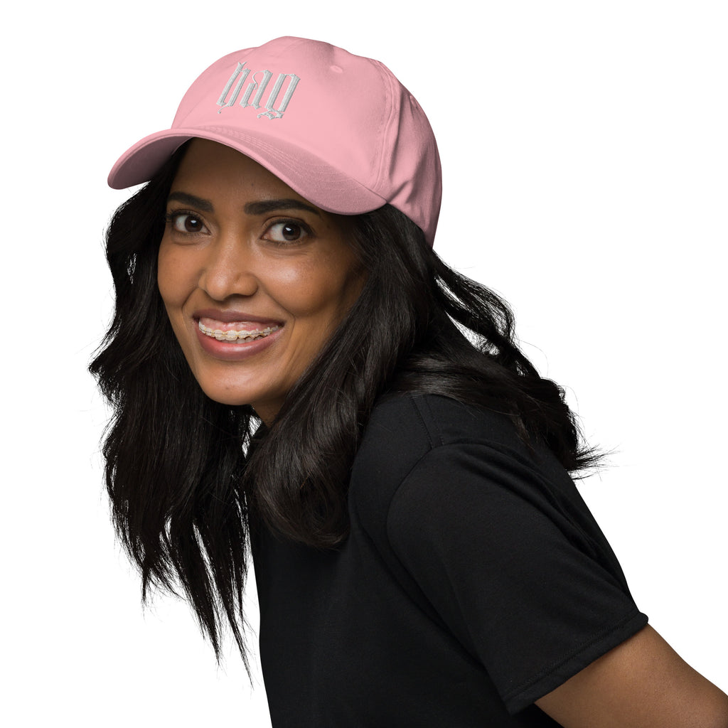 Black dad hat embroidered with the word ‘HAG’ in ornate vintage gothic lettering. Alternative fashion accessory with queer streetwear aesthetic, witchy fashion, sarcastic humor, feminist style, indie fashion, spooky cute apparel, gothic embroidery, punk inspired streetwear, adjustable baseball cap, casual everyday alternative outfit, internet humor fashion, artsy accessory, and edgy statement hat for concerts, festivals, casual wear, and alternative wardrobes.