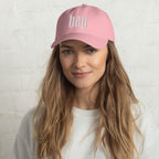 Black dad hat embroidered with the word ‘HAG’ in ornate vintage gothic lettering. Alternative fashion accessory with queer streetwear aesthetic, witchy fashion, sarcastic humor, feminist style, indie fashion, spooky cute apparel, gothic embroidery, punk inspired streetwear, adjustable baseball cap, casual everyday alternative outfit, internet humor fashion, artsy accessory, and edgy statement hat for concerts, festivals, casual wear, and alternative wardrobes.