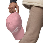 Baseball cap embroidered with the phrase ‘I Have a Cigarette in All 7 Holes’ in ornate vintage gothic lettering. Alternative fashion accessory with edgy internet humor, queer streetwear aesthetic, punk inspired style, ironic meme fashion, tattoo inspired typography, goth streetwear, adjustable dad hat, casual alternative outfit accessory, artsy statement cap, chaotic humor apparel, indie fashion, and expressive alternative clothing for concerts, festivals, everyday wear, and alternative wardrobes.