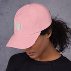 Black dad hat embroidered with the word ‘HAG’ in ornate vintage gothic lettering. Alternative fashion accessory with queer streetwear aesthetic, witchy fashion, sarcastic humor, feminist style, indie fashion, spooky cute apparel, gothic embroidery, punk inspired streetwear, adjustable baseball cap, casual everyday alternative outfit, internet humor fashion, artsy accessory, and edgy statement hat for concerts, festivals, casual wear, and alternative wardrobes.