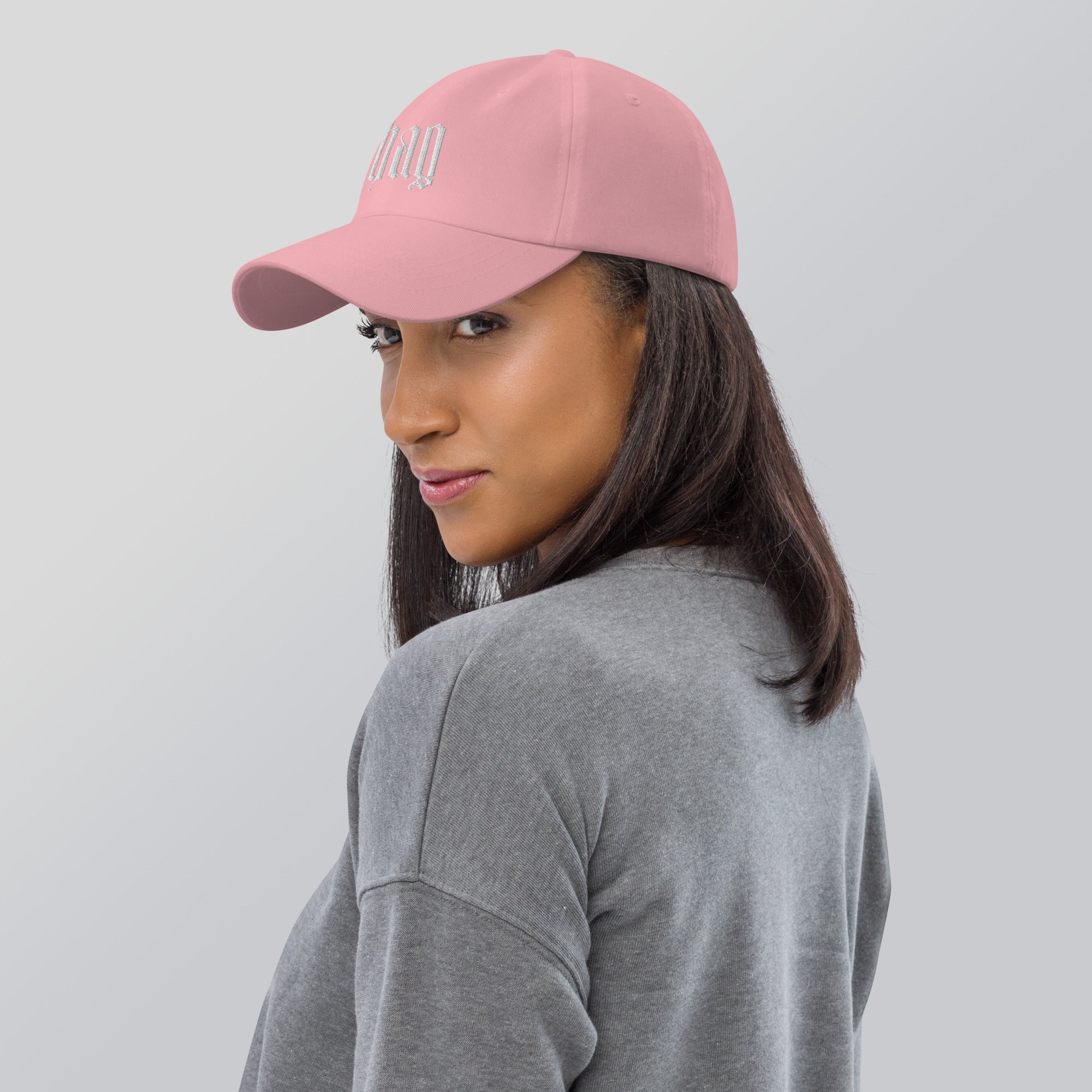 Black dad hat embroidered with the word ‘HAG’ in ornate vintage gothic lettering. Alternative fashion accessory with queer streetwear aesthetic, witchy fashion, sarcastic humor, feminist style, indie fashion, spooky cute apparel, gothic embroidery, punk inspired streetwear, adjustable baseball cap, casual everyday alternative outfit, internet humor fashion, artsy accessory, and edgy statement hat for concerts, festivals, casual wear, and alternative wardrobes.