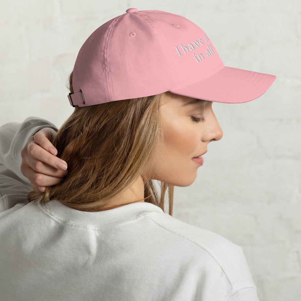 Baseball cap embroidered with the phrase ‘I Have a Cigarette in All 7 Holes’ in ornate vintage gothic lettering. Alternative fashion accessory with edgy internet humor, queer streetwear aesthetic, punk inspired style, ironic meme fashion, tattoo inspired typography, goth streetwear, adjustable dad hat, casual alternative outfit accessory, artsy statement cap, chaotic humor apparel, indie fashion, and expressive alternative clothing for concerts, festivals, everyday wear, and alternative wardrobes.