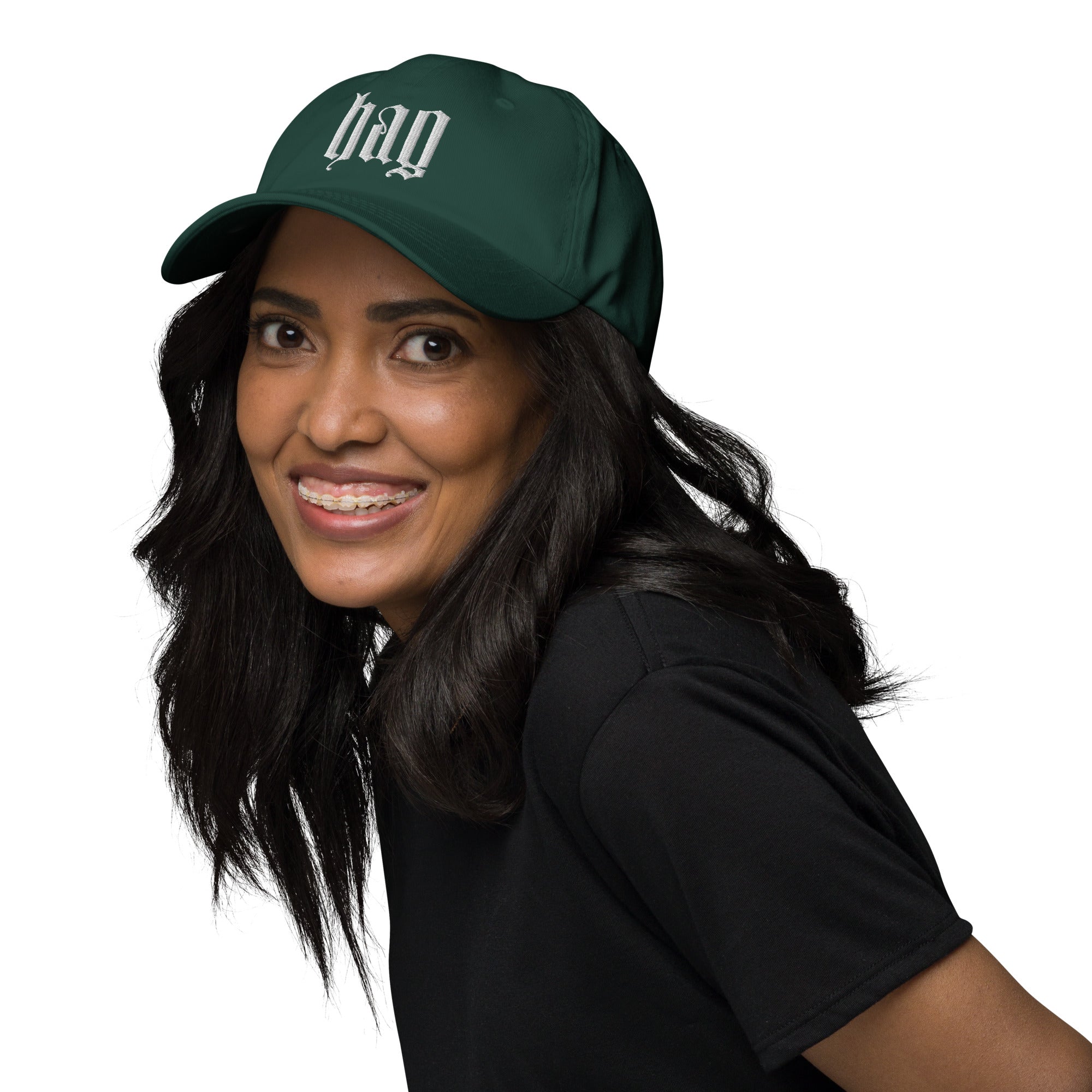 Black dad hat embroidered with the word ‘HAG’ in ornate vintage gothic lettering. Alternative fashion accessory with queer streetwear aesthetic, witchy fashion, sarcastic humor, feminist style, indie fashion, spooky cute apparel, gothic embroidery, punk inspired streetwear, adjustable baseball cap, casual everyday alternative outfit, internet humor fashion, artsy accessory, and edgy statement hat for concerts, festivals, casual wear, and alternative wardrobes.