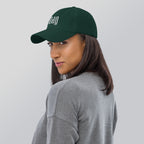 Black dad hat embroidered with the word ‘HAG’ in ornate vintage gothic lettering. Alternative fashion accessory with queer streetwear aesthetic, witchy fashion, sarcastic humor, feminist style, indie fashion, spooky cute apparel, gothic embroidery, punk inspired streetwear, adjustable baseball cap, casual everyday alternative outfit, internet humor fashion, artsy accessory, and edgy statement hat for concerts, festivals, casual wear, and alternative wardrobes.