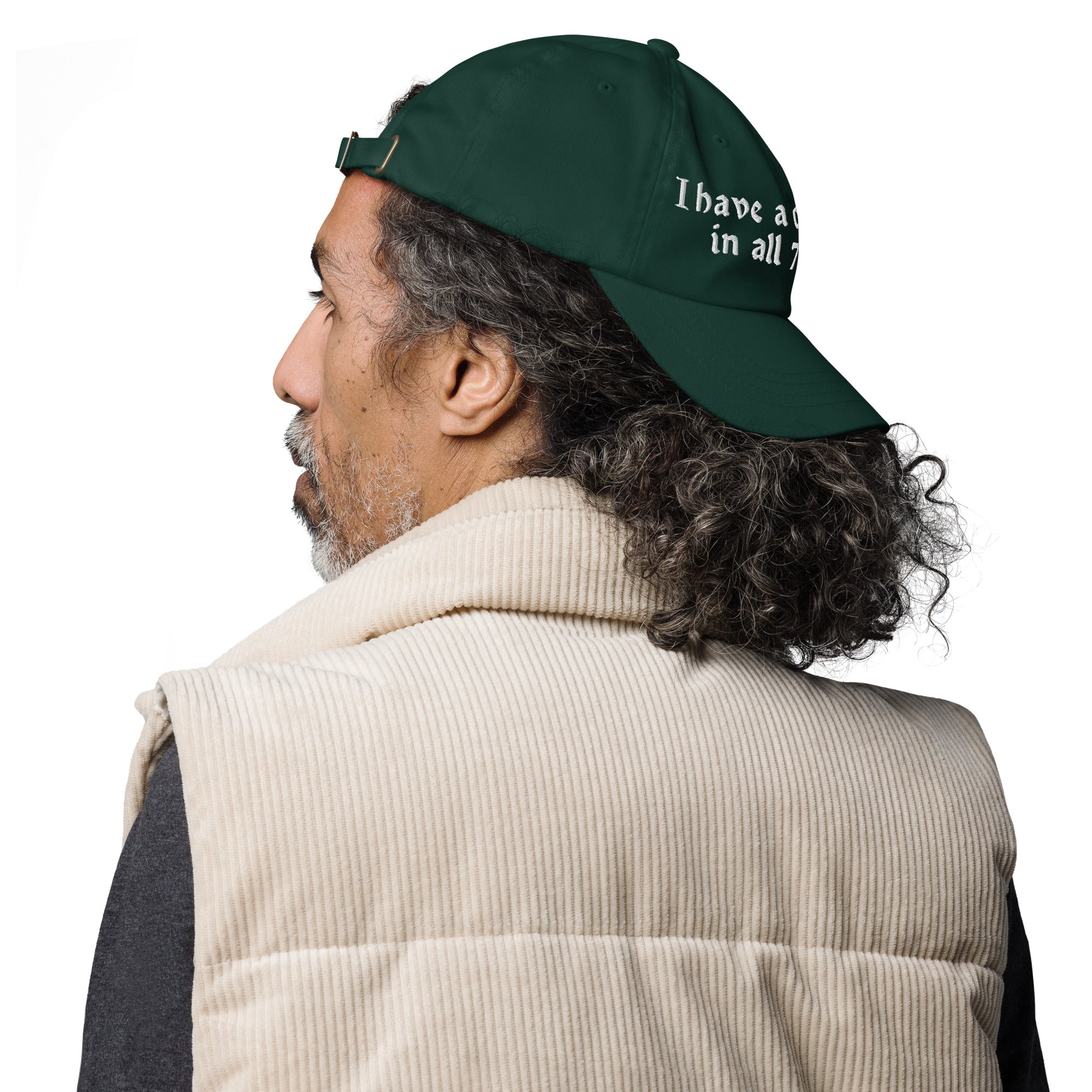 Baseball cap embroidered with the phrase ‘I Have a Cigarette in All 7 Holes’ in ornate vintage gothic lettering. Alternative fashion accessory with edgy internet humor, queer streetwear aesthetic, punk inspired style, ironic meme fashion, tattoo inspired typography, goth streetwear, adjustable dad hat, casual alternative outfit accessory, artsy statement cap, chaotic humor apparel, indie fashion, and expressive alternative clothing for concerts, festivals, everyday wear, and alternative wardrobes.