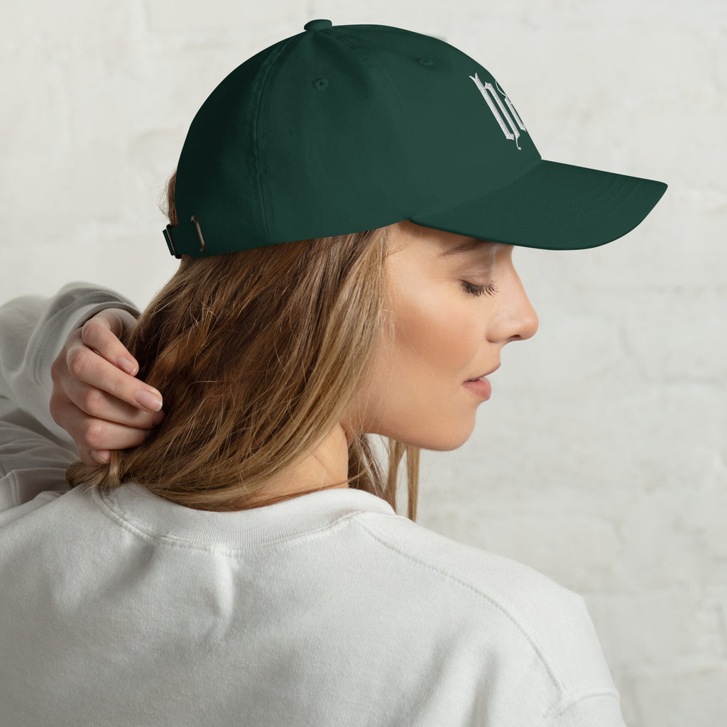 Black dad hat embroidered with the word ‘HAG’ in ornate vintage gothic lettering. Alternative fashion accessory with queer streetwear aesthetic, witchy fashion, sarcastic humor, feminist style, indie fashion, spooky cute apparel, gothic embroidery, punk inspired streetwear, adjustable baseball cap, casual everyday alternative outfit, internet humor fashion, artsy accessory, and edgy statement hat for concerts, festivals, casual wear, and alternative wardrobes.
